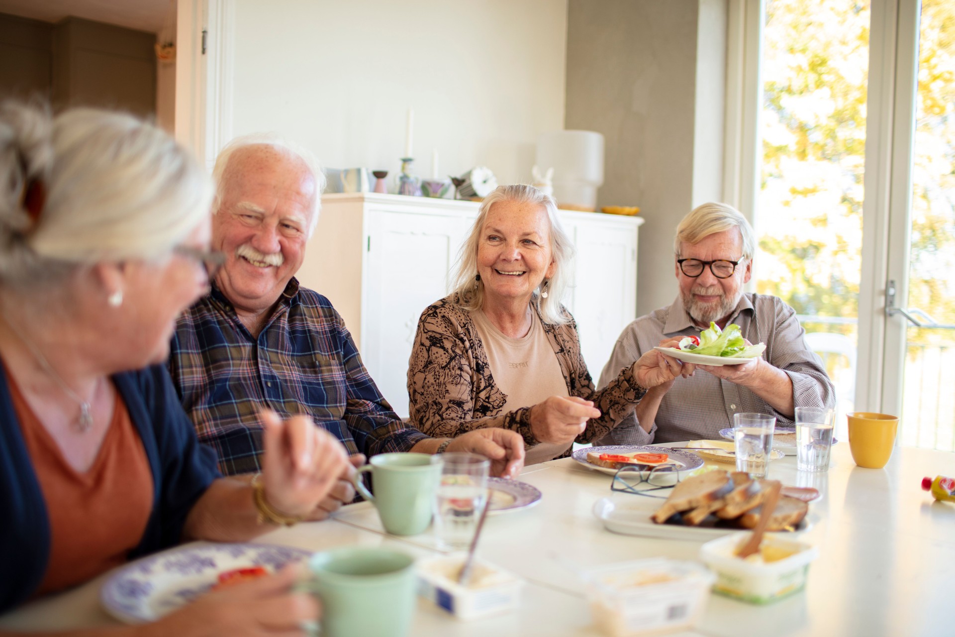 Small group of seniors having breakfast together