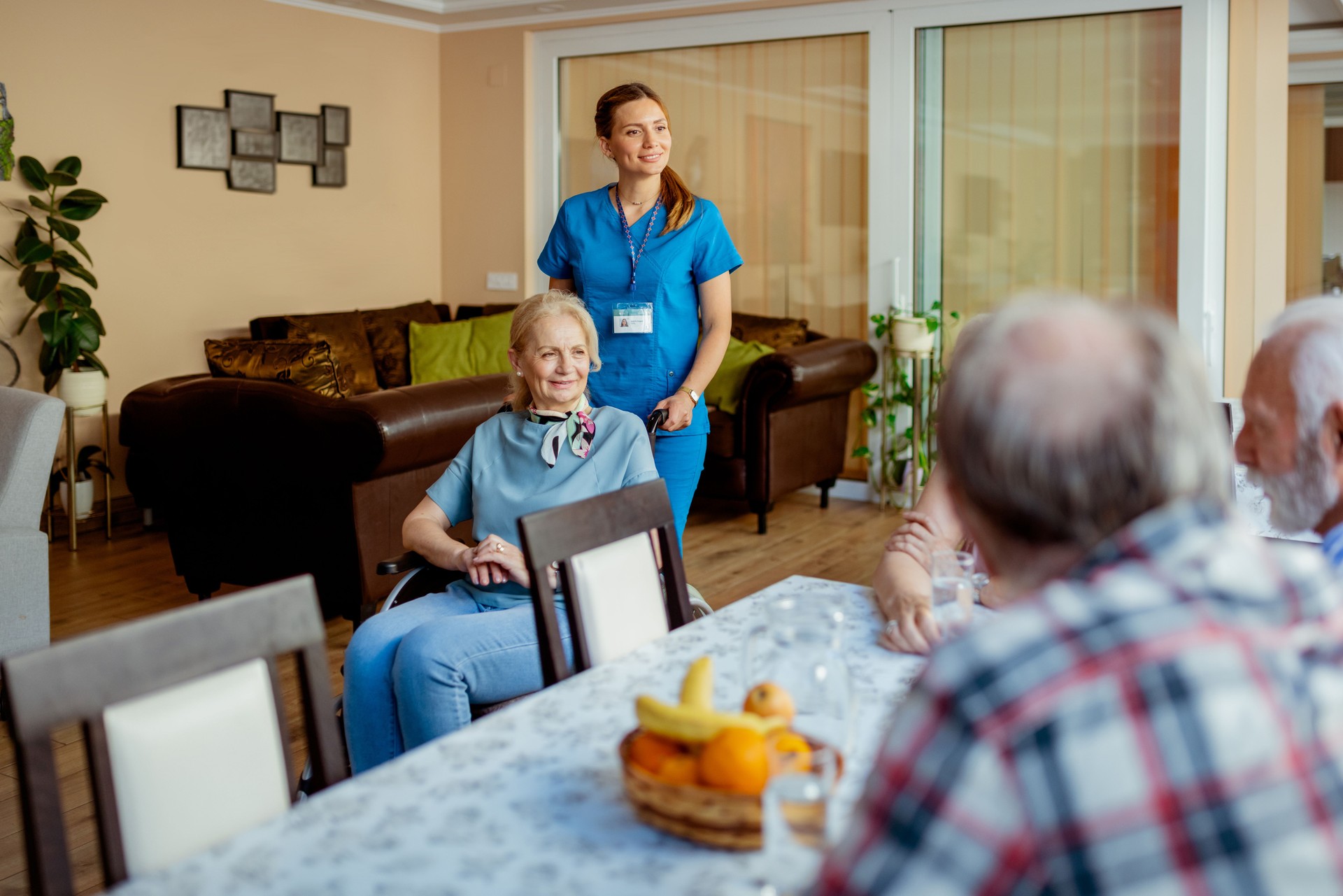 Senior People and Their Caregiver Talking in Living Room at Nursing Home