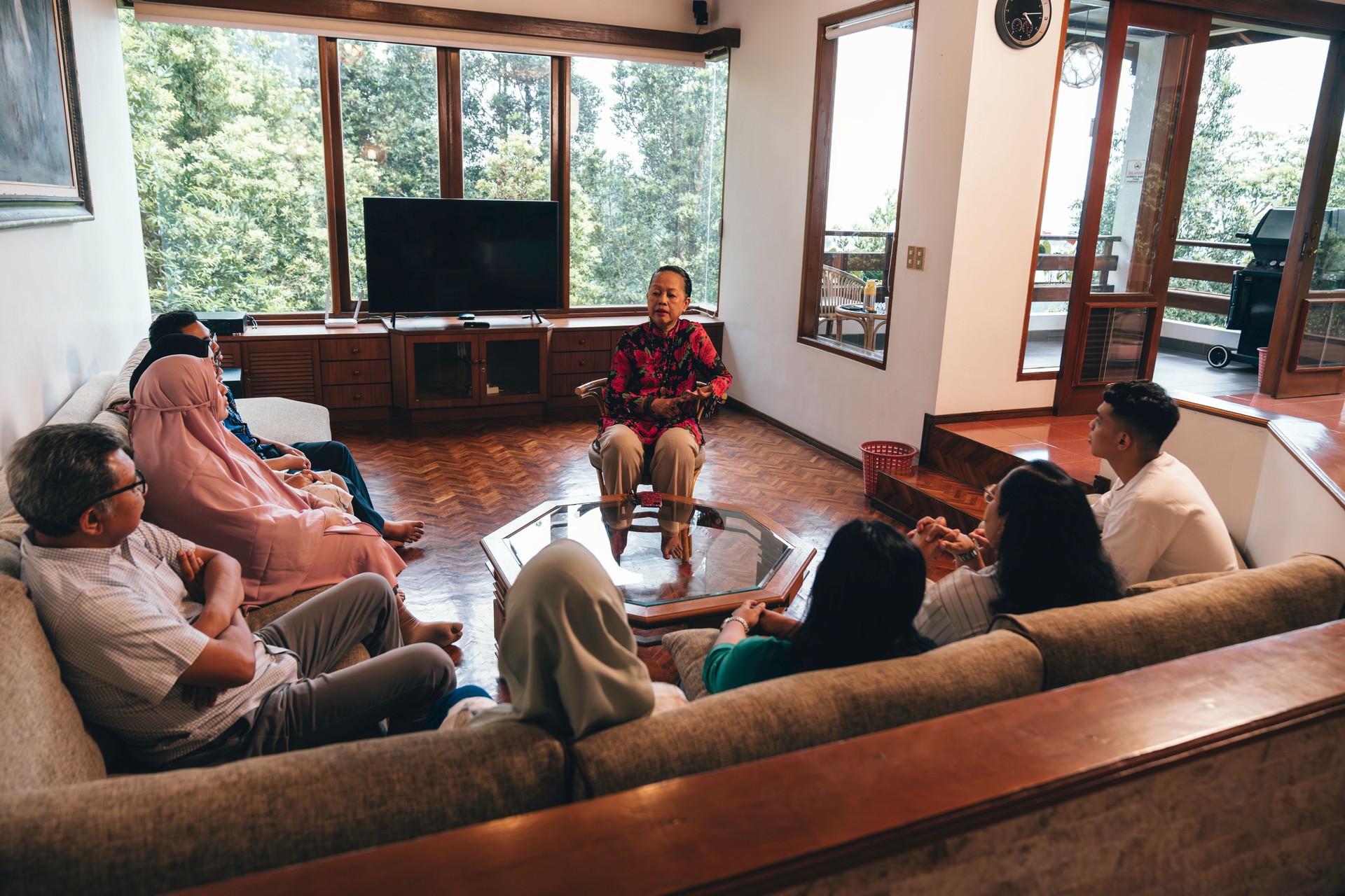 a group of people are taking each other while sttiing on a sofa in large living room