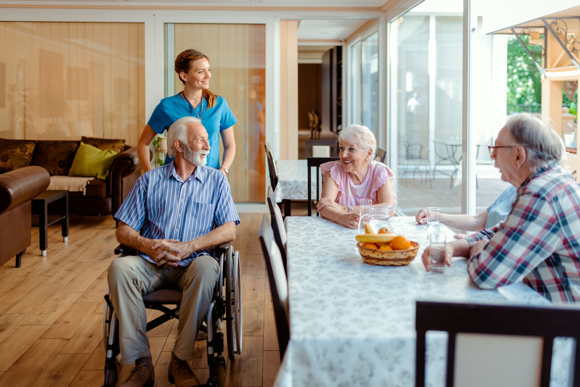 Happy Senior People and Their Caregiver Talking at Nursing Home